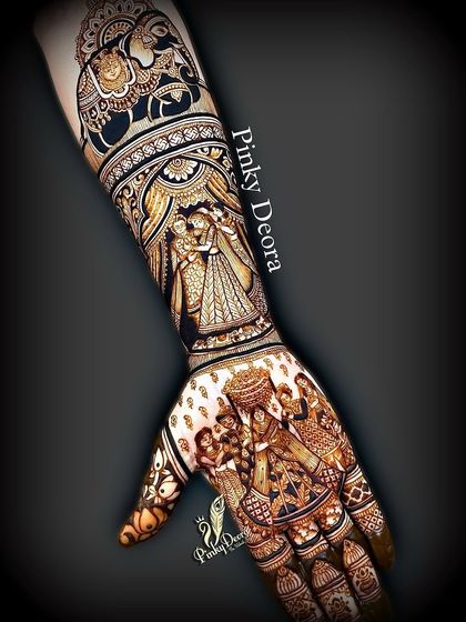 A dramatic and intricate bridal design, featuring multiple scenes from a wedding ceremony, including the couple's portrait and processional elements.