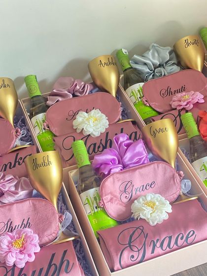 A vibrant and fun bridesmaid hamper option, with personalized robes and eye masks, custom wine glasses, and mini wine bottles.