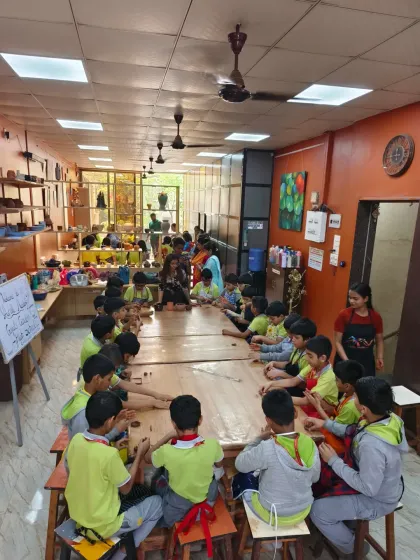 A full classroom of young students from Gopal's Garden School, deeply engaged in a hand-building session. Our studio is equipped to host school groups and private events, offering a fun, educational, and hands-on artistic experience.