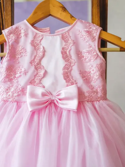 I designed this pink tulle dress with a delicate lace-embroidered bodice. It’s a classic princess silhouette that brings so much joy and is perfect for birthdays or any special day.