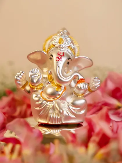 A small yet powerful silver-plated Ganesha idol, perfect for a personal desk or a small niche. The intricate details and the Om symbol on his trunk are a reminder of his constant blessings.
