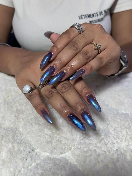 A long, stiletto set with a mesmerizing blue-purple chrome finish. I teach the proper application of chrome powders for a flawless, mirror-like effect.