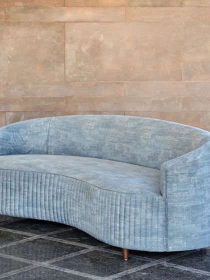 The Ivy Sofa, with its fluid, curved form and pleated upholstery, offers a quiet yet distinct presence. Designed to embrace and comfort, it is a beautiful and functional centerpiece for any living space.