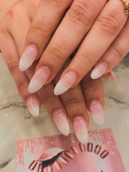 A timeless classic, the baby boomer ombre. This elegant design features a seamless gradient from a soft pink base to a clean white tip on long almond-shaped extensions, perfect for any occasion.