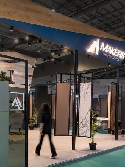 The open-sided design of the Makers Laminate pavilion encourages entry from multiple points. The structure uses a framework of pillars that double as display stands for large laminate samples.