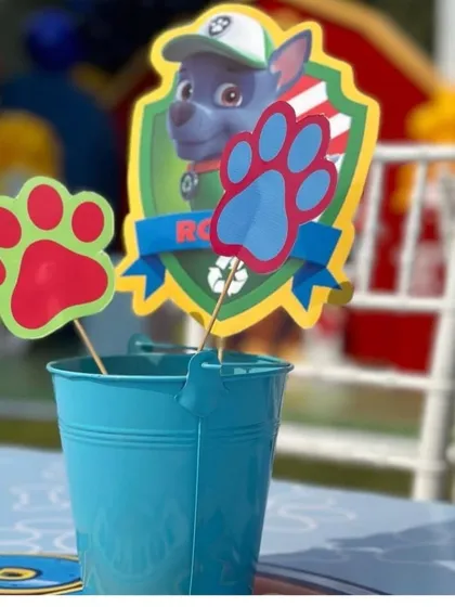 It's all in the details. This custom Paw Patrol centerpiece featuring Rocky adds a personalized touch to the party tables.