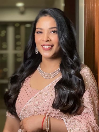 A beautiful, happy portrait. The makeup enhances her natural smile and radiant energy.