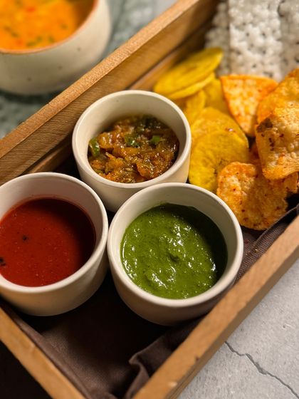 The papad and chutney platter from our Navratri menu. We offer a variety of house-made chutneys with different flavor profiles to accompany the meal.