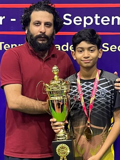 Celebrating another one of our champions holding his trophy at the state championship. Each win is a result of a personalized training plan and the player's dedication to the sport.