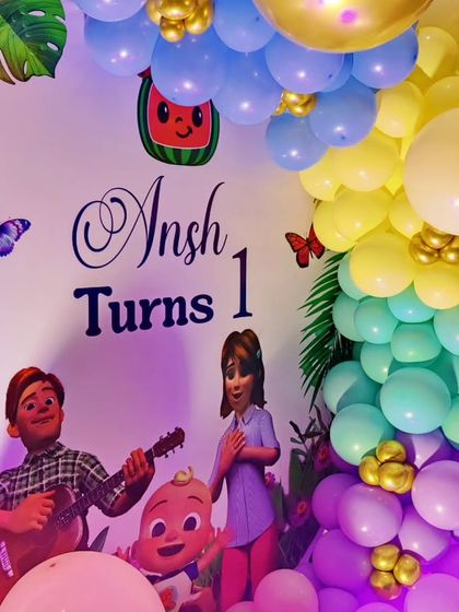 A close-up of a Cocomelon and Boss Baby-themed backdrop, featuring characters from both shows.