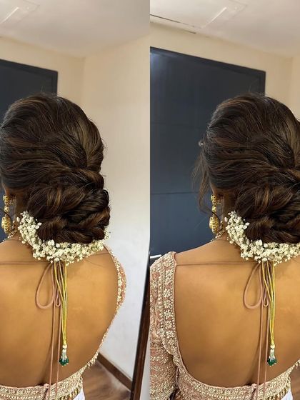 A detailed look at a textured and braided bun adorned with baby's breath. This style combines the elegance of a bun with the intricacy of a braid, perfect for a sophisticated bridal look.