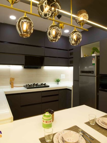 This angle shows the U-shaped layout of the kitchen, which provides ample counter space and an efficient work triangle.