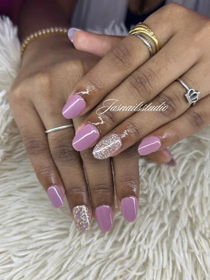 A lovely mauve polish with a gold glitter accent nail. This is a great way to add a little something extra to a simple manicure.