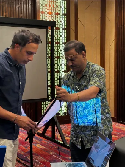 We emphasize learning by doing. In this photo, an attendee gets hands-on experience setting up a professional-grade measurement microphone, a crucial first step in the acoustic analysis and room correction process.