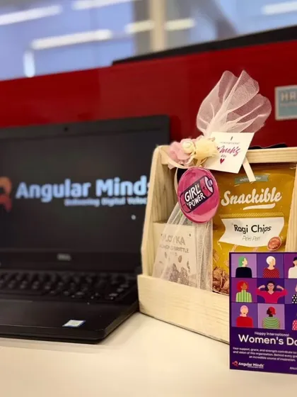 A Women's Day gift basket displayed on an employee's desk at Angular Minds, showing our gifts in their natural corporate habitat.