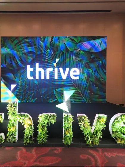 We bring brand stories to life with impactful corporate event decor. For the 'thrive' summit, we designed and fabricated large-scale 3D lettering filled with fresh greenery, creating a powerful and photogenic stage presence that reinforces the event's theme.
