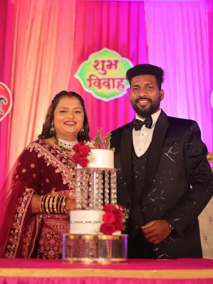This couple looks so happy as they stand by their wedding cake. We love being a part of these joyous "Shubh Vivah" moments.