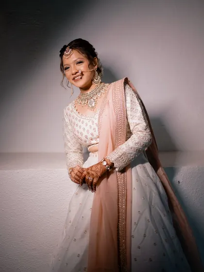 A happy, relaxed portrait of the bride. Her natural, joyful expression is the centerpiece, enhanced by a fresh and minimal makeup look that lets her personality shine through.