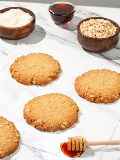 A top-down shot of oatmeal honey cookies with their core ingredients. This deconstructed styling helps tell the story of natural, wholesome ingredients.
