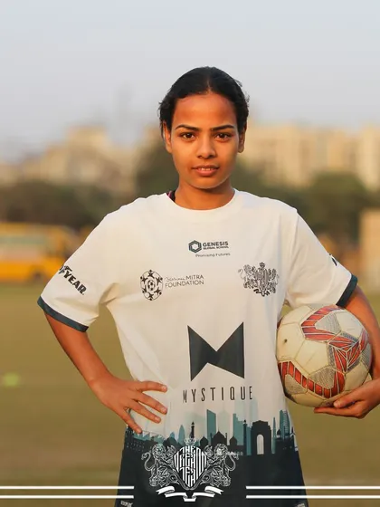 Holding the ball, holding the future. A player from our women's team, ready to make her mark.