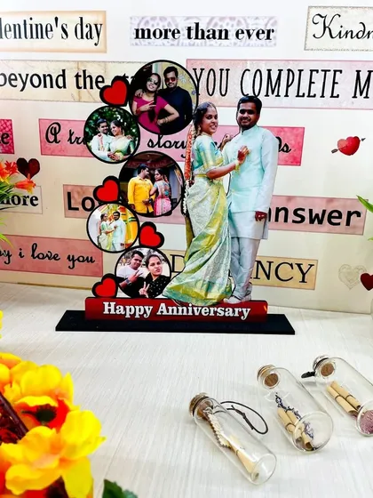 A beautiful anniversary gift, this tabletop display features a full-size cutout of the couple alongside a cascade of smaller photos from their journey together.