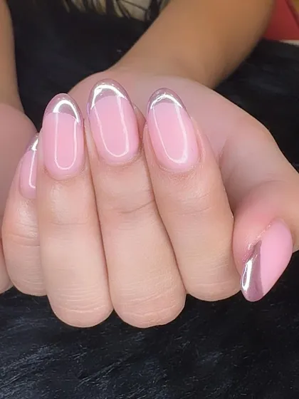 A close-up of lavender chrome French tips, outlining the nail for a modern, "outlined" effect.