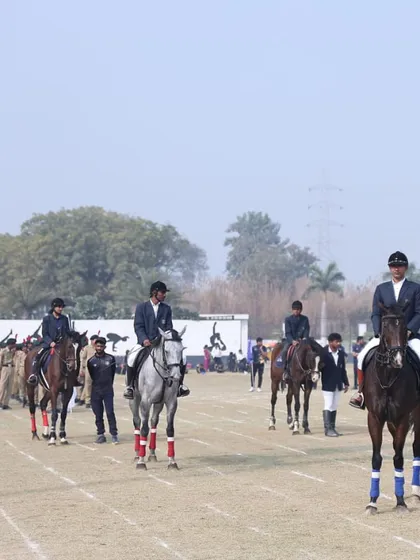 Our riders participate in a parade during an annual sports day, demonstrating their skills and the proud tradition of equestrian sports.