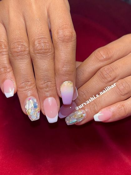 This set combines multiple techniques for a unique bridal look. It features classic French tips alongside a purple ombré nail and accent nails with shattered glass and gold foil details.