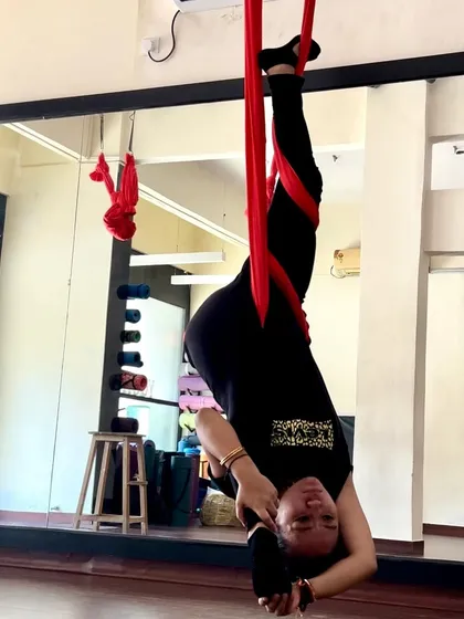 Splits can be explored from any angle. This inverted variation uses gravity to assist in the stretch, offering a new perspective on a classic yoga pose.