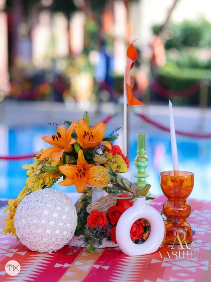 Another angle of the playful centerpiece, showing the unique shapes of the vases and the vibrant color combination.