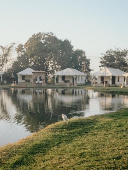The serene setting of the Champaner Heritage Resort, which inspired the stationery for this picturesque wedding. The calm lake and tented accommodations were translated into beautiful illustrations.