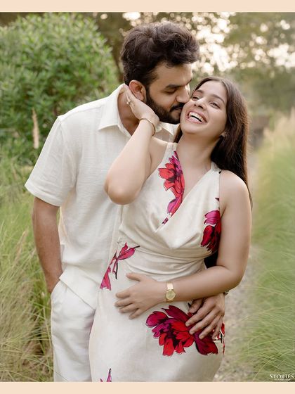 A candid and joyful portrait from a pre-wedding shoot in a park in Delhi. The genuine laughter and embrace make this image feel warm and full of life.