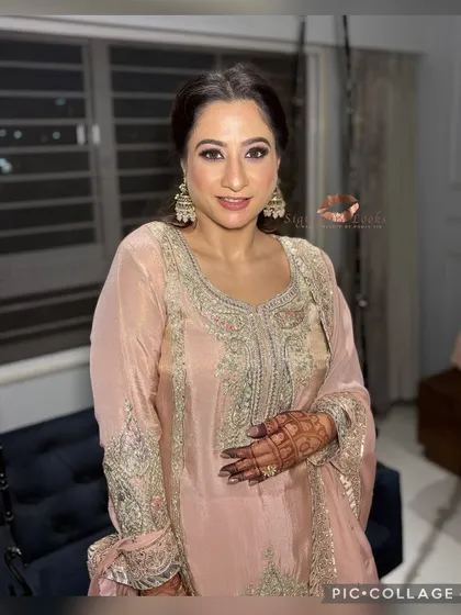 A full-length view of the client. The hairstyle is balanced and doesn't overwhelm her embroidered outfit, creating a harmonious overall look.