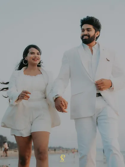 A joyful, walking shot on the beach. The movement in her hair and their happy expressions capture the carefree spirit of a destination pre-wedding shoot in Goa.