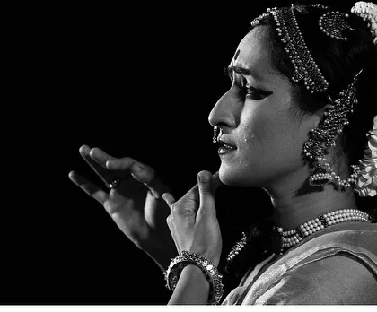 A black and white close-up, focusing on the expressive quality of the hands and face in storytelling.