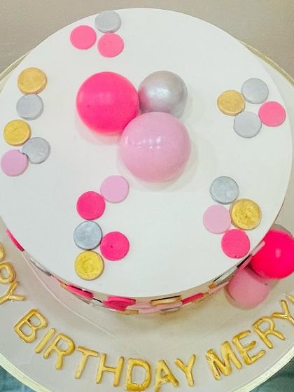 A top-down view of the whimsical polka dot cake, showing the fun arrangement of colors.