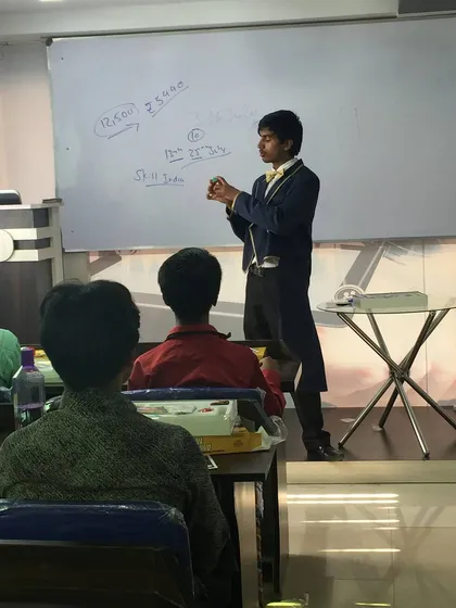 I believe in breaking things down step-by-step. Here, I'm demonstrating a sleight of hand technique to the class, ensuring everyone understands the method before they try it.