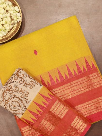 A Kanchi cotton saree in yellow with a hand-painted blouse piece, a comfortable and artistic choice for daytime wear.