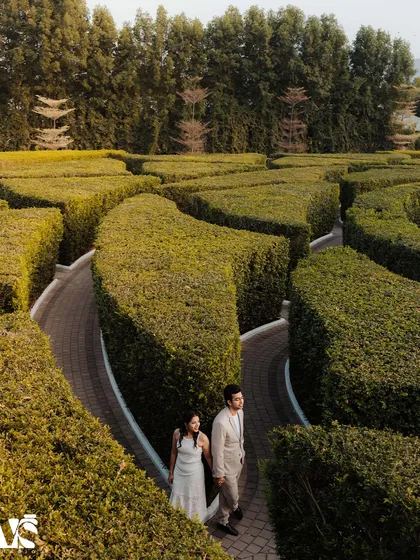 A breathtaking aerial view of a couple navigating a hedge maze together. This image symbolizes the journey of love and is a perfect example of how we capture surprise proposals in the most creative and meaningful ways.