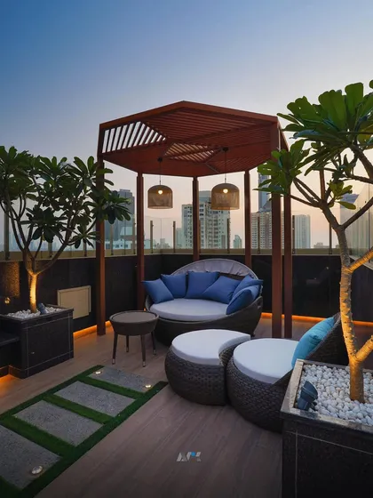 A detailed shot of the lounge area on the Lower Parel residential rooftop. The design uses natural materials and soft lighting to craft a serene escape high above the bustling city.