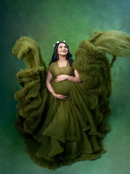We had so much fun creating this angelic look. By tossing the ruffled green gown, we created the illusion of wings, giving this maternity photo a magical, ethereal quality.