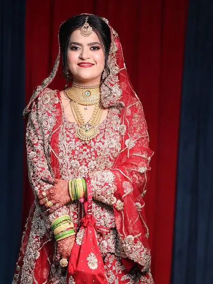 My beautiful doctor bride, all set for her Nikah. We went for a natural finish HD base that looks like real skin, paired with a classic red lip and gold jewelry.