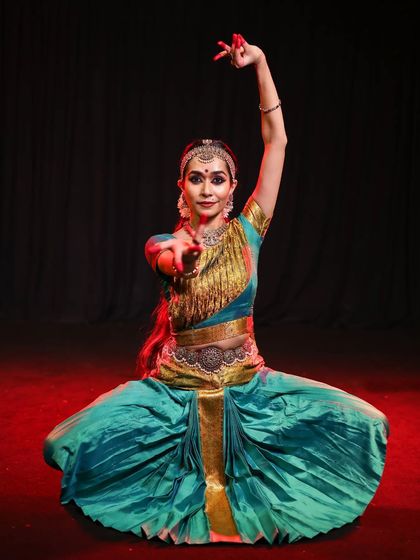This full-body shot demonstrates how the makeup contributes to the dancer's overall stage presence. Even from a distance, the facial features are distinct and expressive.