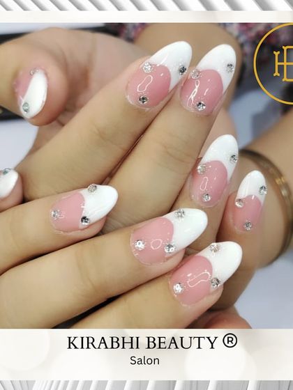 A delicate and romantic design. I used a soft pink and white base and placed individual rhinestones to create a subtle, sparkling heart shape.