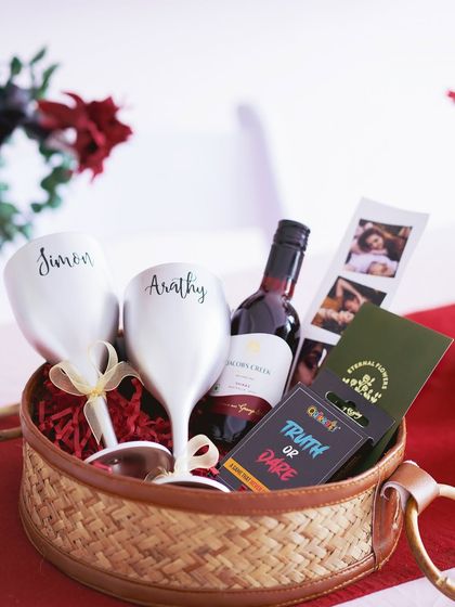A different angle of the 'Romantic Escape' hamper, highlighting the elegant, custom-named wine glasses.