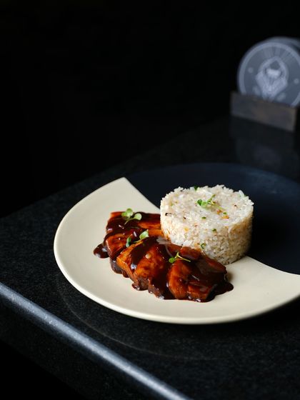Our Belgian Pork Belly is slow-cooked with cinnamon, five-spice powder, and honey. We serve this succulent dish with a side of fragrant garlic rice.