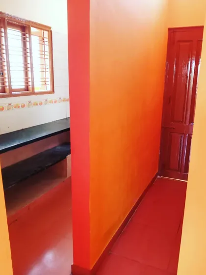 This is from a recent project in Kengeri where the client wanted a warm and energetic feel. We used a combination of bright orange and red to transform this hallway and kitchen entrance.