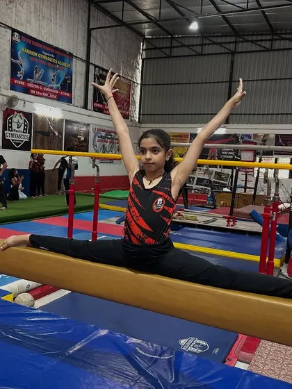 The balance beam demands absolute focus. This gymnast demonstrates a perfect split, showcasing the flexibility and poise we develop for our beam routines. It’s a testament to her dedication and our structured training approach.