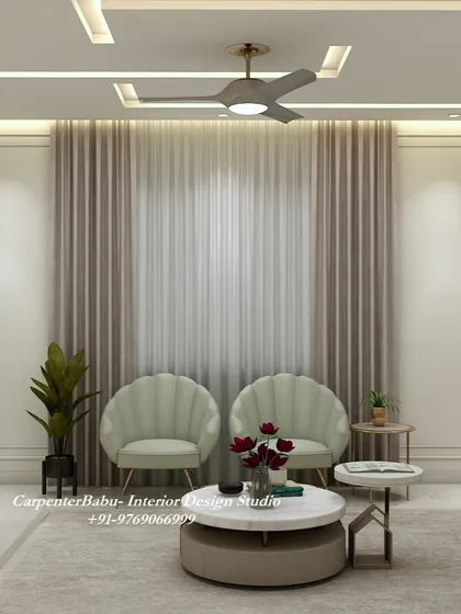 A cozy seating arrangement with two shell-back chairs in a soft green fabric. The simple wall paneling and large window create a bright and relaxing corner.