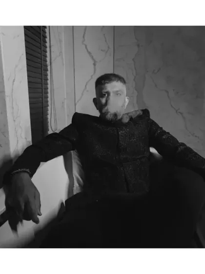 The groom steals the spotlight. This dramatic, high-fashion shot of the groom in a bathtub is all about style and swag, amplified by the moody black and white aesthetic.